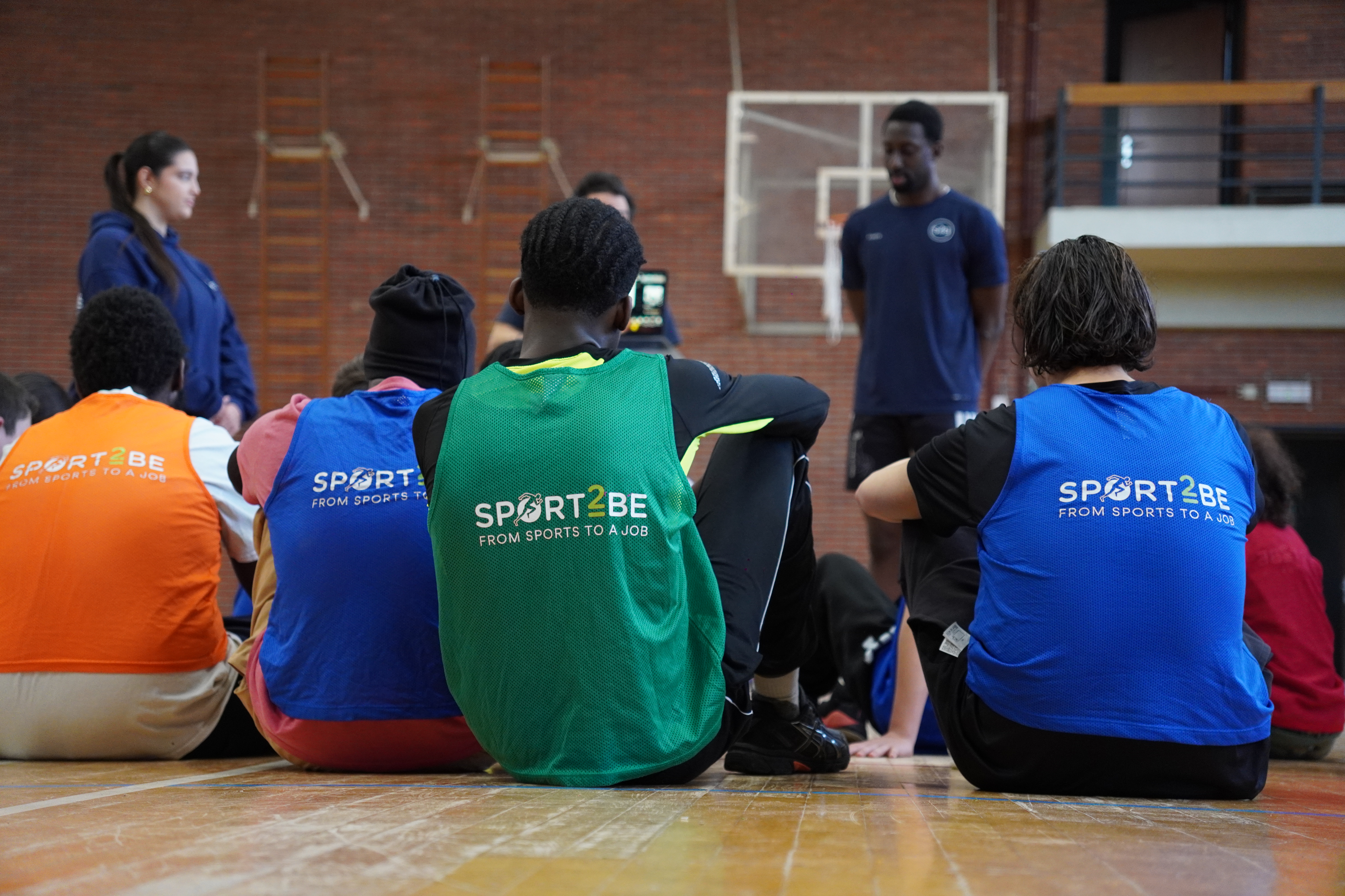 Sport2Be coach leading a free football training session with young teenagers